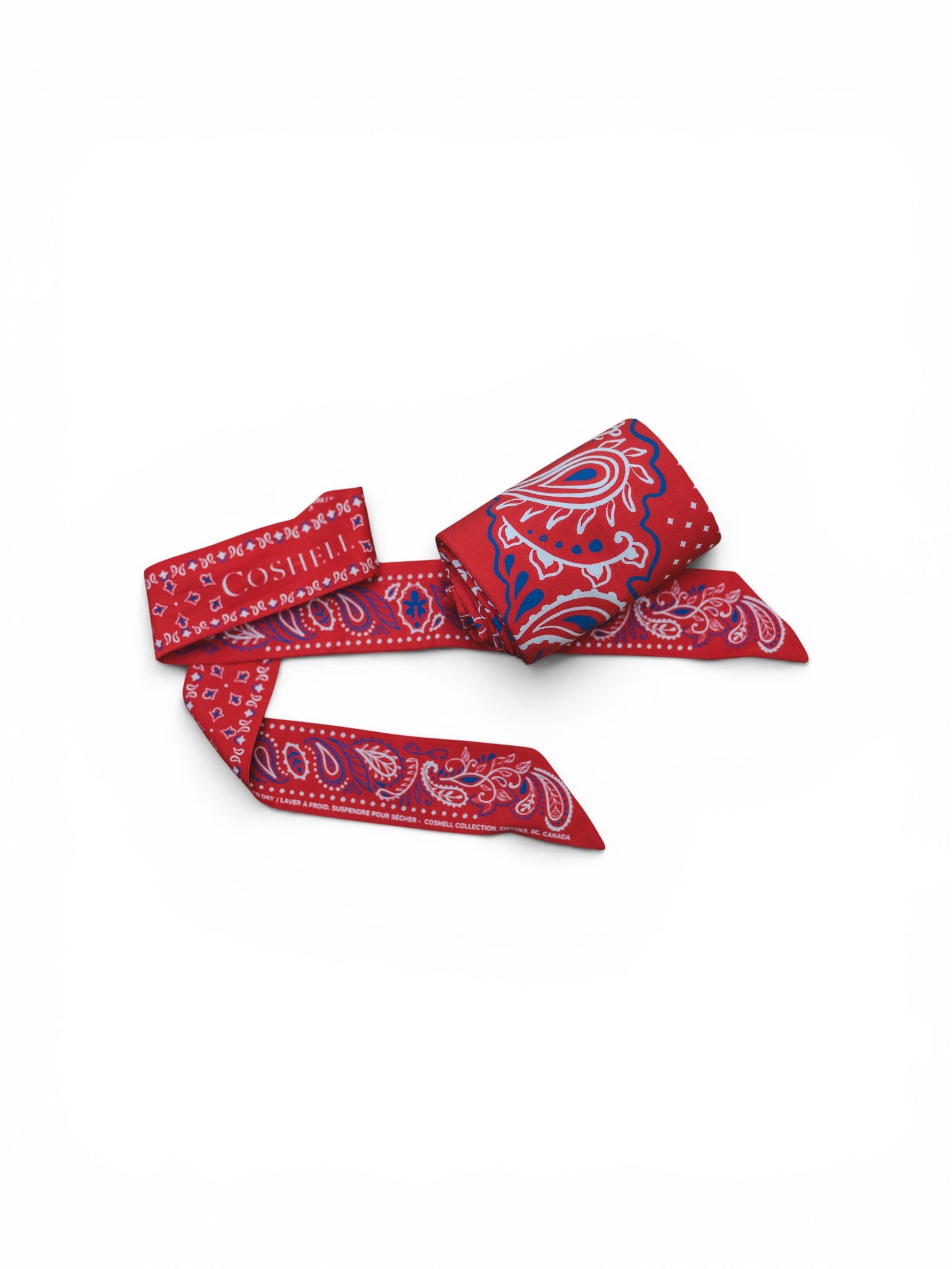 A red cotton twilly scarf and a sarong bundle with a paisley pattern, featuring the brand name 'COSHEL' printed in white and blue 